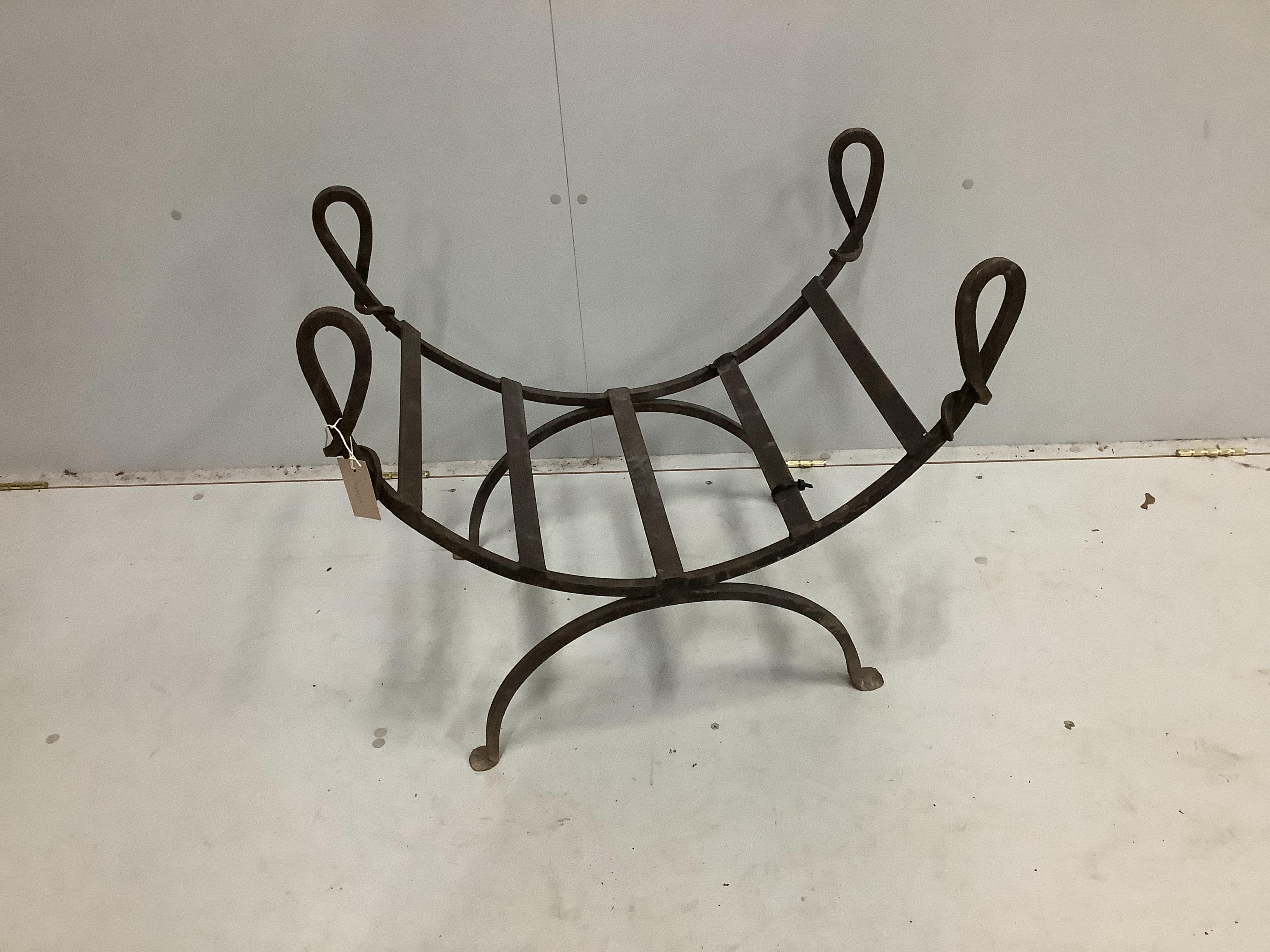 A wrought iron log stand, width 72cm, depth 47cm, height 64cm